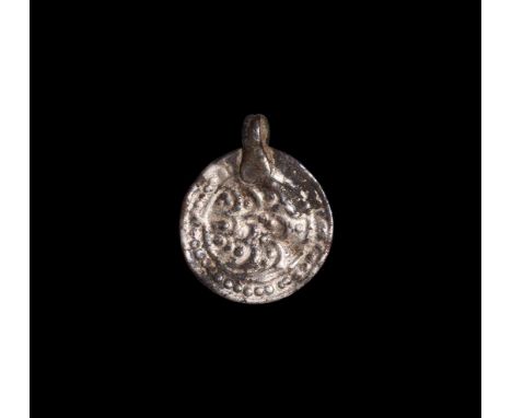 9th-11th century AD. A silver discoid pendant with applied suspension loop, repoussé rosette design. Cf. Montelius, O. Sverig