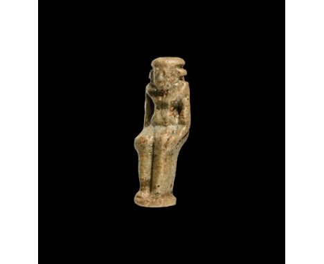 New Kingdom, 1550-1070 BC. A dark green glazed composition amulet of Horus the Child (Harpocrates) nude seated with sidelock 