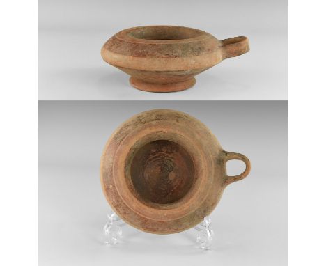7th-5th century BC. A ceramic exaleiptron vessel with rolled rim, deep shoulder and wide base with D-shaped handle to one sid