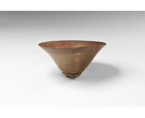 Song Dynasty, 960-1279 AD. A ceramic bowl with thin flared rim, covered in a mottled dark glaze streaked with fine russet-col