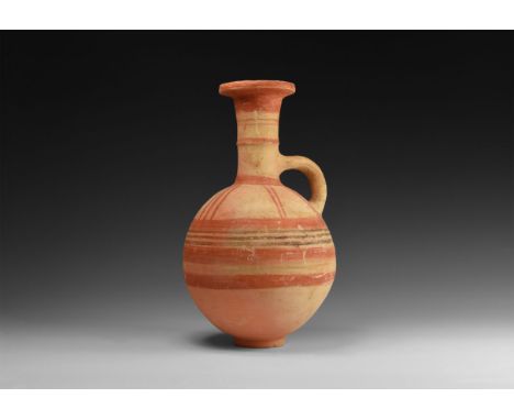 12th-10th century BC. A terracotta globular jug with basal ring, trumpet-shaped neck with median fillet, everted and chamfere