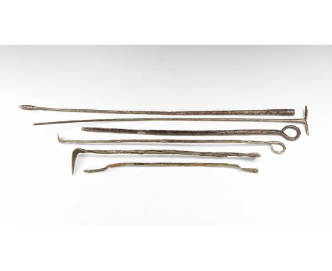 12th-15th century AD. A mixed group of iron tools including a spoon-bit augur, a ladle with looped finial, a poker and other 