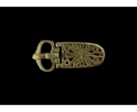 8th-10th century AD. A bronze heart-shaped buckle with tongue curved over the forward edge of the loop; hinged belt plate wit