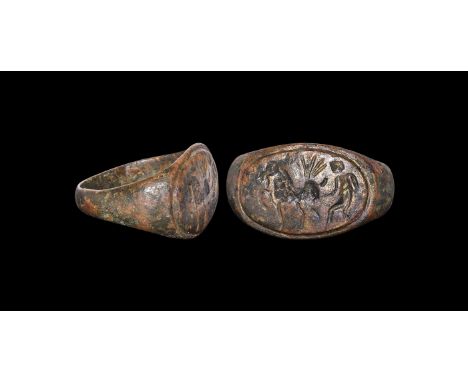 1st century BC-1st century AD. A D-section bronze hoop with flared shoulders, elliptical bezel with intaglio image of a man a