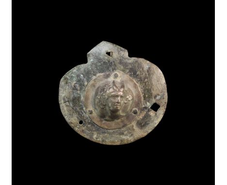1st-2nd century AD. A bronze oval phalera with tang to the top; to the centre a high relief repousse image of a satyr, head t