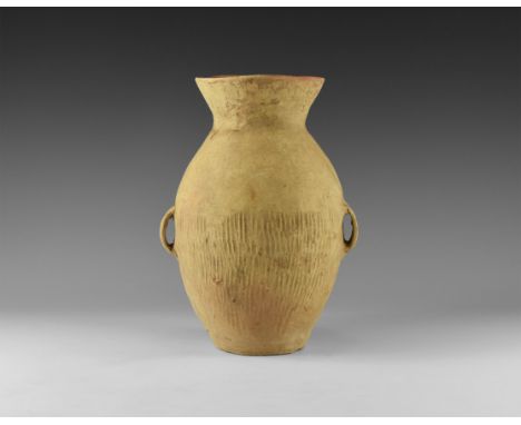 Neolithic, 3rd millennium BC. A biconvex ceramic jar with flared rim, ridged leather texture to the body and shoulder, two st