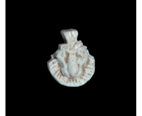 Hyksos Period, 17th-16th century BC. A pale blue glazed composition amuletic pendant, aegis with facing lion's head and radia