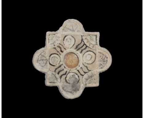 14th-16th century AD. A gesso wall tile square with a D-shaped lug to each edge, central hole; painted rings, quadrants, wavy