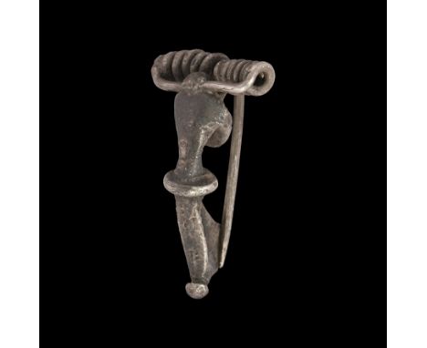 1st century AD. A silver bow brooch of kraftig profilierte type with trumpet bow, coiled collar, swept foot with balustered t