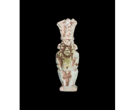 Third Intermediate Period, 1069-702 BC. A pale blue bifacial figure of Bes standing on a square base, wearing the feather hea