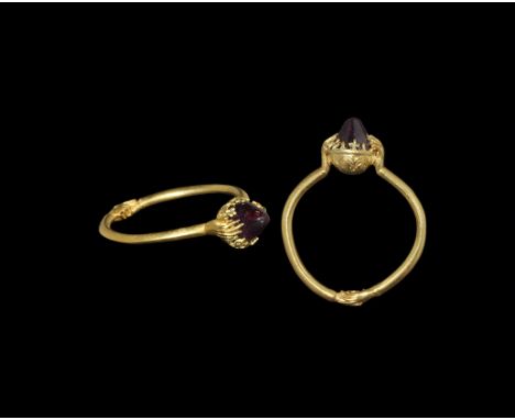 14th-15th century AD. A narrow round-section hoop with delicate clasped-hands motif modelled in the round to the underside, b