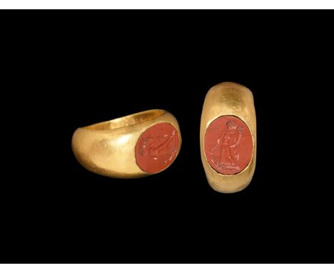 1st-2nd century AD. A gold ring with D-section hoop widening at the shoulders; flat bezel set with a jasper intaglio engraved