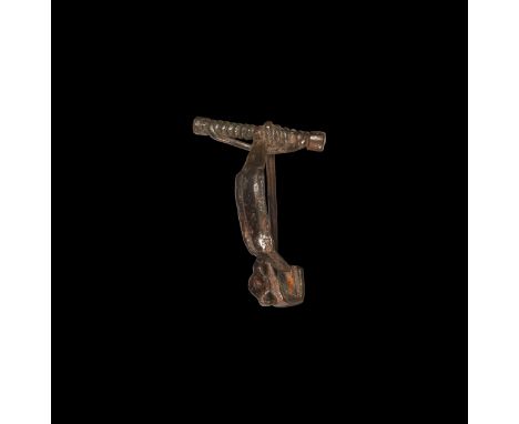 4th-3rd century BC. An iron La Tène I bow brooch with integral pin and spring on crossbar, broad bow with raised median panel