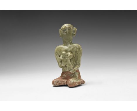 14th-16th century AD. A green-glazed ceramic figurine of a nude seated female suckling a baby in her arms.  233 grams, 12cm (