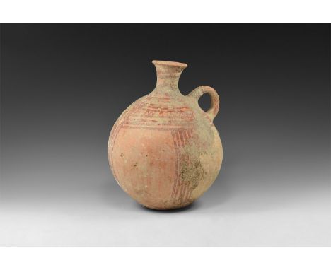 Iron Age, 12th-6th century BC. A tall ceramic Holy Land jar with rounded body, short tubular neck and flared rim, loop handle