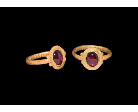 4th-5th century AD. A gold finger ring comprising a hollow-formed D-section hoop, discoid bezel with granules to the shoulder