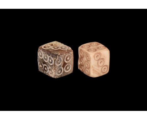 1st-4th century AD. A pair of bone dice engraved to each side with ring-and-dot motif for numbers.  1.97 grams, 8mm (1/2"). P