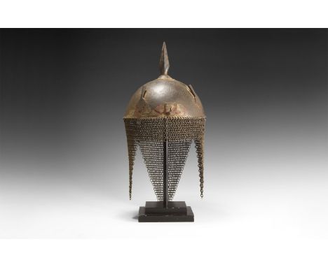 18th century AD. An iron helmet comprising a domed bowl with pierced rim, bracket to accept an adjustable nasal, two leaf-sha
