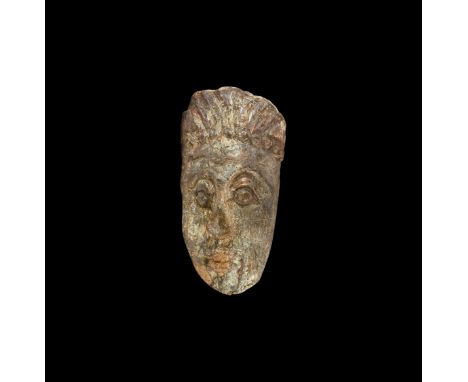 Pliocene Period, 5.2-2.5 million years BP. A Mastodon fossil tusk, with later carving in the form of a grotesque human face. 