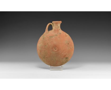 5th-6th century AD. A ceramic flask with discoid body, short flared spout and one handle.  662 grams, 21cm (8 1/4"). Acquired