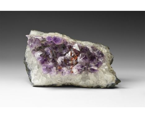 . A segment of a geode with amethyst to the inner face of the haematitic matrix, from Brazil.  1.5 kg, 19.5cm (7 3/4"). Ex Dr