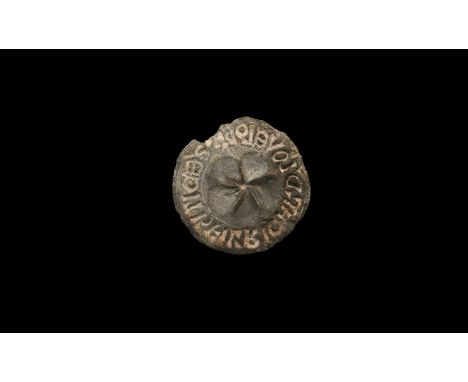 14th century AD. A large lead discoid seal matrix with chamfered rim, low-relief fleur-de-lys and lug; to the underside, cinq