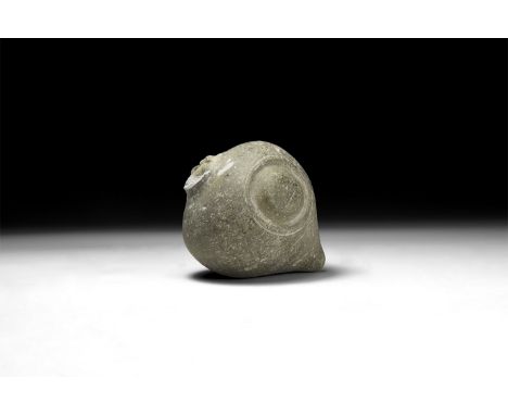 9th-11th century AD. A hollow-formed piriform ceramic vessel with low rim to the mouth; two lateral bulbs each within a shall