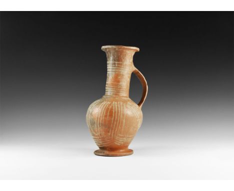 2nd millennium BC. A terracotta vessel with tapering lower body, flared basal ring, broad sloping shoulder with rib, flared n