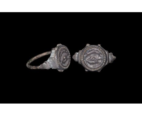 6th-7th century AD. A bonze ring with thin round section hoop widening to a stylised acanthus leaf to te shoulder; round beze