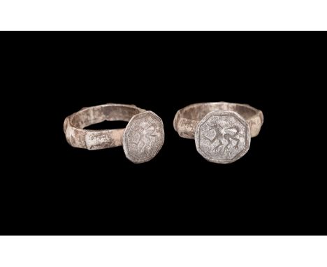 10th-12th century AD. A silver ring with flat section hoop with seven knops to the outside; raised hexagonal bezel engraved w