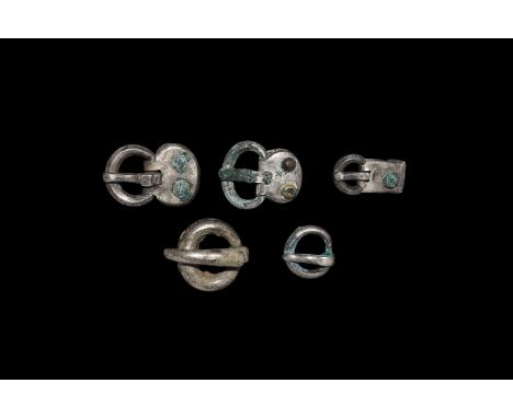 5th-7th century AD. A mixed group of silver buckles comprising: a round-section ring with flat tongue; a round-section ring w