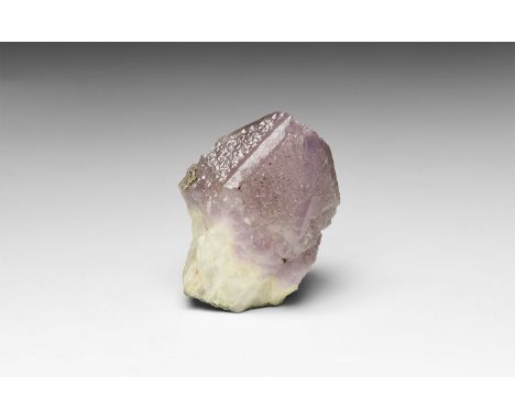 . A specimen of amethyst, a singular stubby pyramidal terminated crystal developed from a colourless crystalline mass with mi