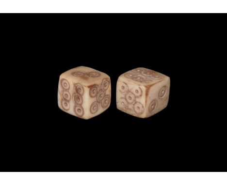 1st-4th century AD. A pair of bone dice with engraved ring-and-dot to each side for the numbers.  2.07 grams total, 7mm (1/4"