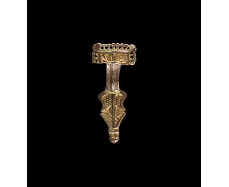 5th-7th century AD. A silver-gilt bow brooch comprising: a rectangular headplate with gilt panel and openwork border, ribbed 