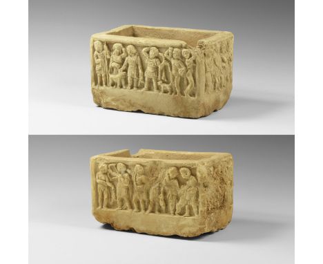 3rd-4th century AD. A marble casket carved in high relief on all four sides depicting Diana and Apollo; Side A: a male figure