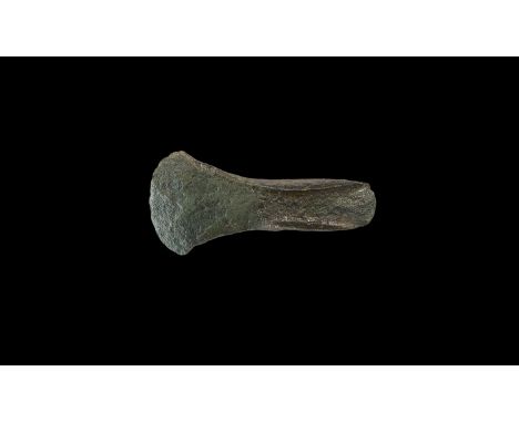 2nd millennium BC. A substantial palstave axehead with spatulate blade; to each face, two convergent lateral wings forming a 