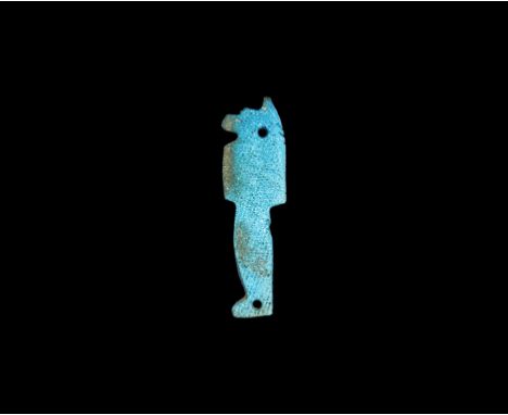Late Period, 664-332 BC. A bright blue glazed composition flat-section or 'degenerate' amulet of Anubis with two stitching ho