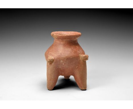 Shang Dynasty, 1600-1046 BC. A ceramic vessel with flared rim and short neck; bulbous body with three long legs, two with fel