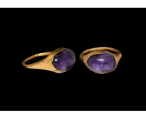 1st century BC. A hollow-formed gold finger ring with D-section hoop, elliptical bezel with inset amethyst cabochon. Cf. Chad