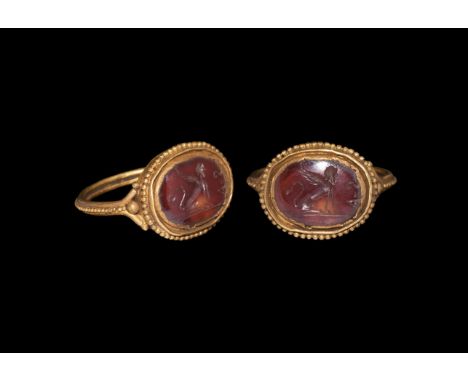 1st-2nd century AD. A gold finger ring comprising a round-section hoop with band of granules to the outer edge, granules to t