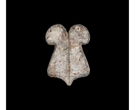 Late Dynastic Period, 664-332 BC. A flat stone amulet of addorsed curled feathers peseh kef with scooped lower edge, median d