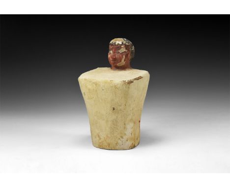 Middle Kingdom, 2133-1797 BC. A carved wooden crouching ancestor figure, head protruding from the body enveloped in a white g
