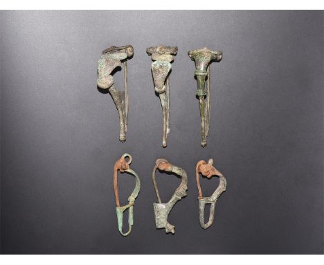 2nd century AD. A mixed group of bronze bow brooches, trumpet-shaped and P-shaped types.  104 grams total, 54-72mm (2 1/4 - 3