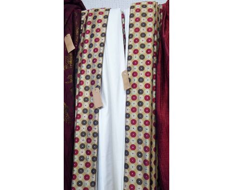 CURTAINS, a pair, in a geometric circled fabric lined, 240cm x 228cm drop. (2)