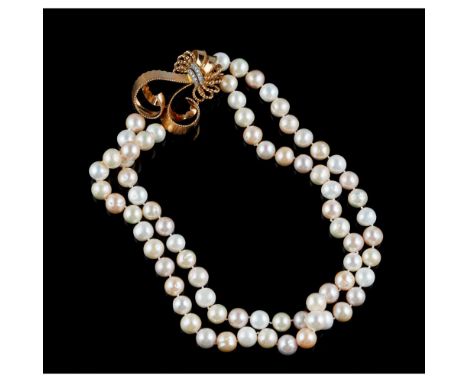 A pearl necklaceComprising of 2 fresh water pearls strandsBicoloured gold claspSet with 14 8/8 cut and brilliant cut diamonds