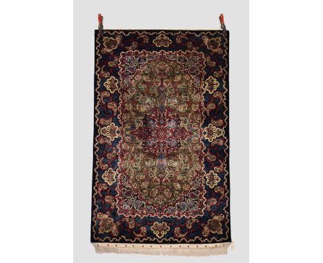 Tabriz silk rug, north west Persia, circa 1950s, 5ft. 8in. X 3ft. 5in. 1.73m. X 1.04m. Small tears to flatweave ends. Olive g