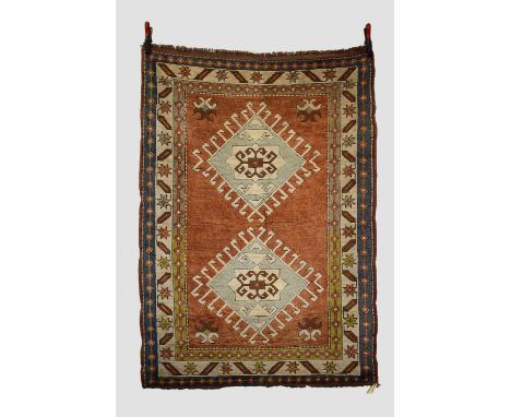 Kars Kazak rug, east Anatolia, second half 20th century, 5ft. 10in. X 4ft. 1in. 1.78m. X 1.25m. Light brown field with two pa