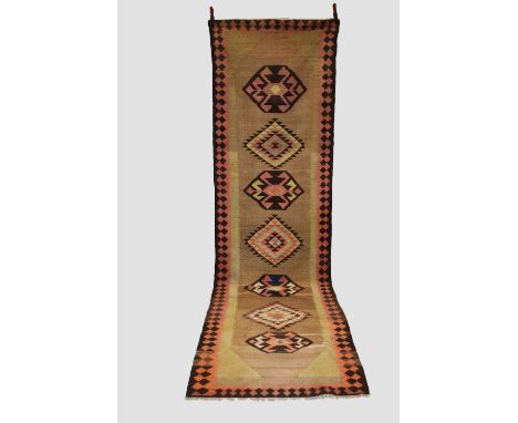 North west Persian ghileem runner, circa 1940s,  13ft. 7in. X 3ft. 10in. 4.14m. X 1.17m. Small holes to one end. Camel field 