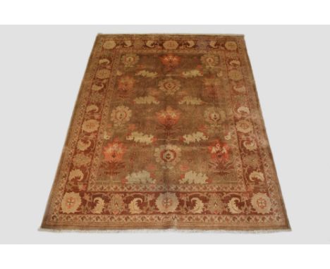 Indian carpet, modern production, 9ft. 4in. X 6ft. 11in. 2.85m. X 2.11m. Few very small surface marks. Pale walnut field with