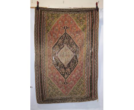 Senneh ghileem, north west Persia, circa 1920s-30s, 6ft. 6in. X 4ft. 5in. 1.98m. X 1.35m.  Overall wear with splits and tears